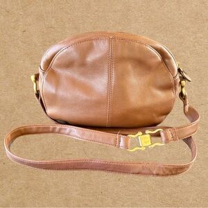 Brown leather crossbody bag. Gold tone hardware on the strap,& zipper.